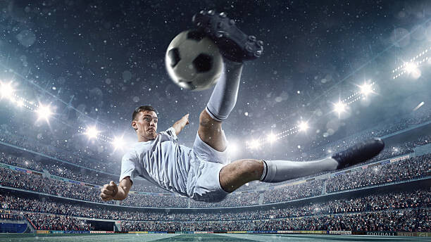 Canvas Print Soccer player kicking ball in stadium