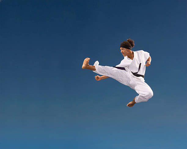 Canvas Print Teenage boy  kicking in mid-air,