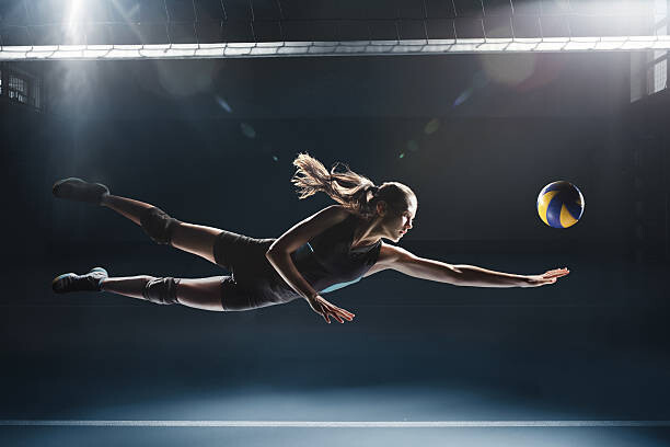 Canvas Print Volleyball player jumping to the ball
