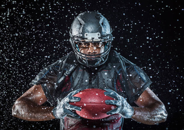 Canvas Print Water splashing on Black football player