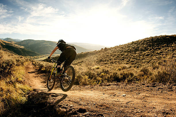 Canvas Print Woman flying on a downhill mountain bike.