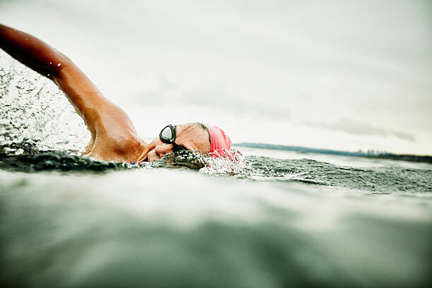 Canvas Print Woman taking a breath during open water swim