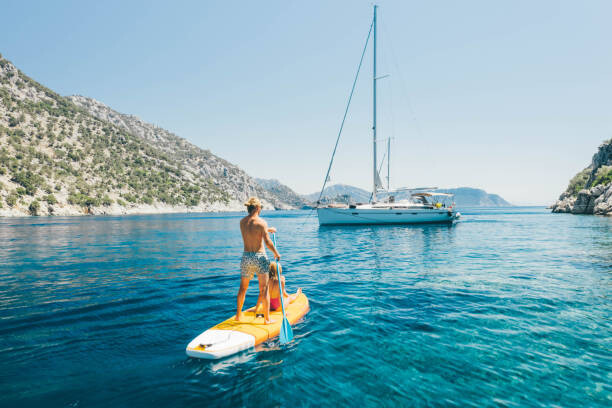 Canvas Print Young couple paddling on stand up