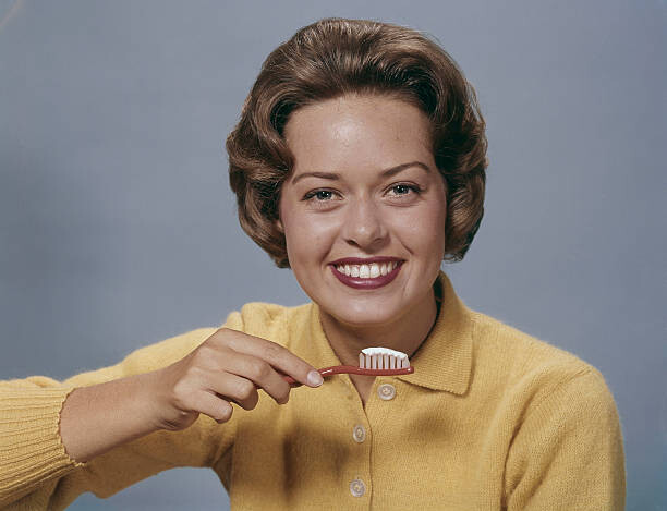 Canvas Print Young Woman Brushing Teeth