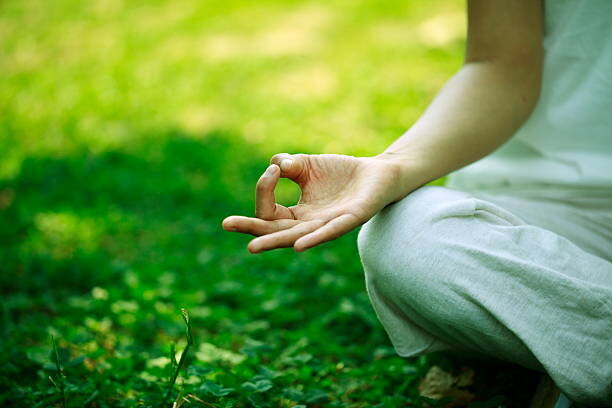 Canvas Print young woman doing yoga,hand close-up