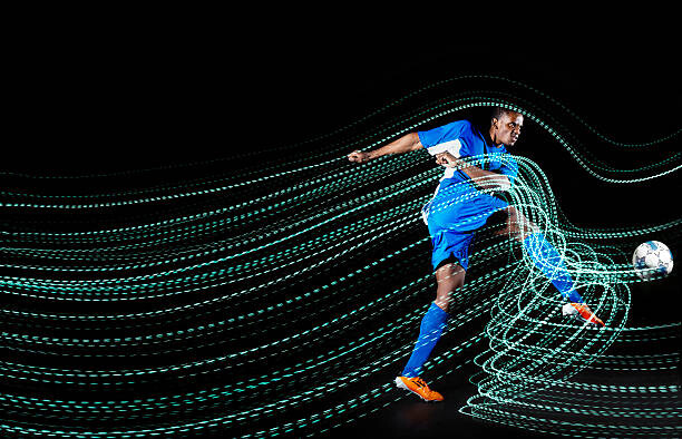 Canvas-taulu Football/ soccerplayer with lighttrace