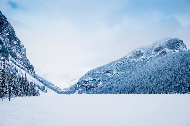 Canvas-taulu Snowy mountains in remote landscape, Lake
