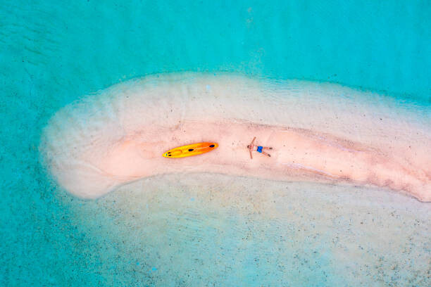Juliste Man relaxing on a sandbar with
