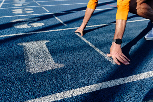 Juliste Sportsman at starting line of running track