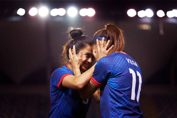 Juliste Two young athletes touch their heads