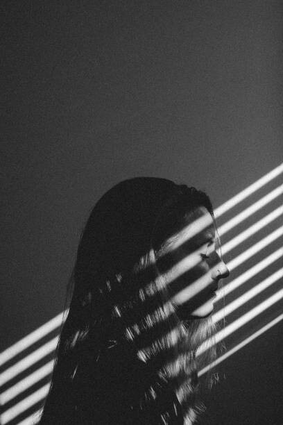 Juliste Young Woman With Light Steaming on Face