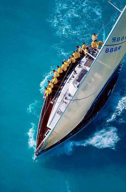 Bilde på lerret Sailing Team Sitting on Edge of Boat