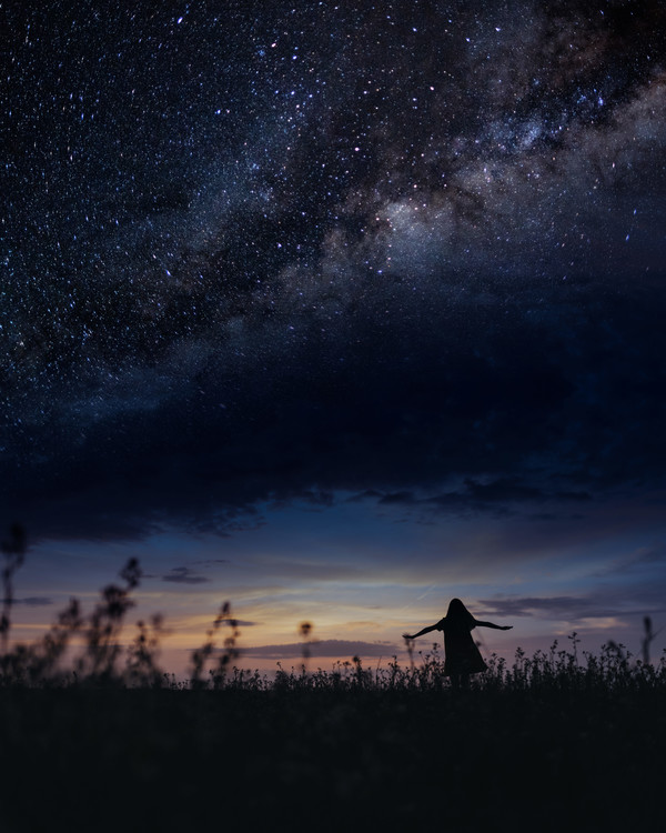 Art Photography Scene with woman dancing under milky way