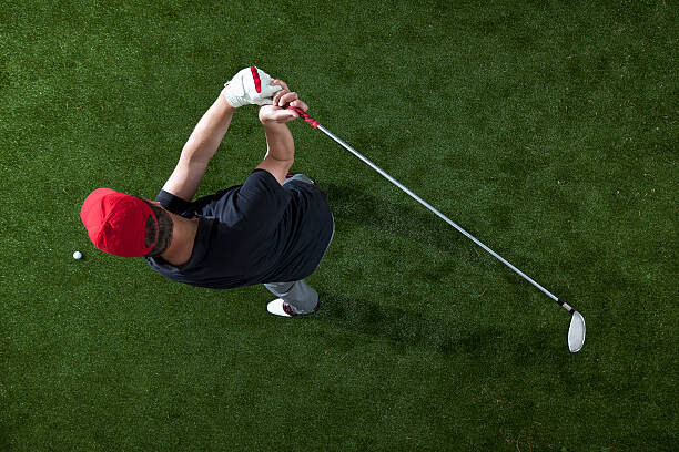 Murais de parede A golfer swinging a golf club, overhead view