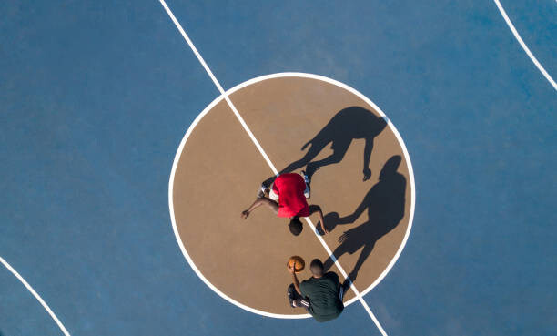 Murais de parede Aerial shot of 2 basketball players and shadows