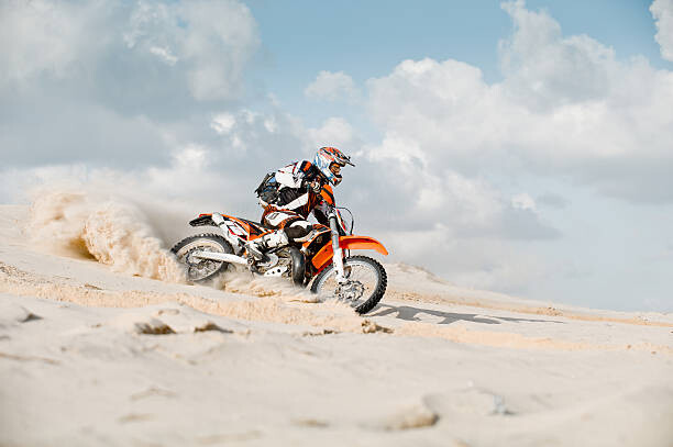 Plakat motor cross riding over sand