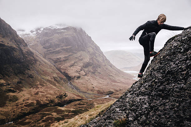 Poster A free runner climbs a steep mountain rock face