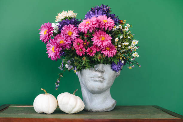 Poster Head-shaped vase with a bouquet of flowers.