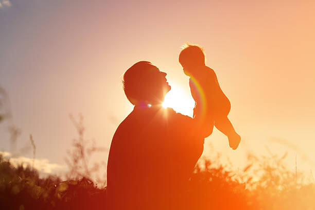Slika na platnu Father and little newborn daughter silhouettes