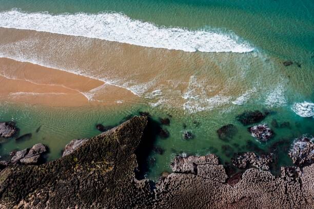 Poster Aerial view, water lapping rocky coast, Portugal