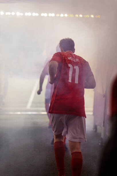 Poster A professional male soccer player jogs