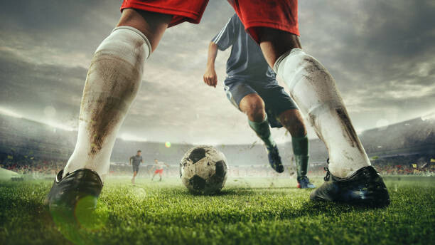 Poster Close up legs of football or