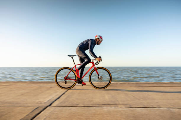 Poster Cyclist on path by sea
