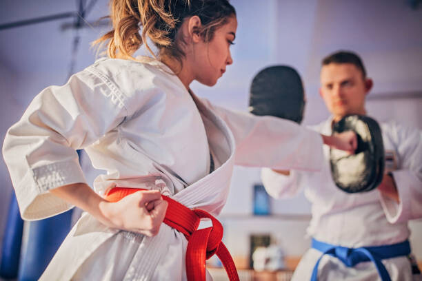 Poster Female karate player practicing with trainer