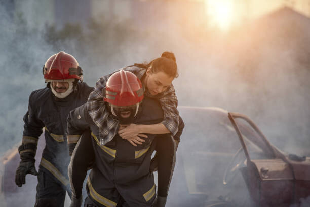 Poster Firefighters rescue a woman, carrying her