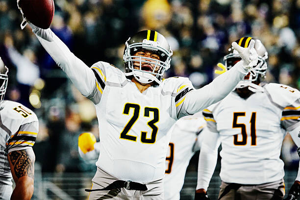 Poster Football player celebrating with teammates