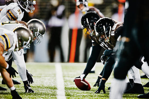 Poster Football teams on line of scrimmage in stadium