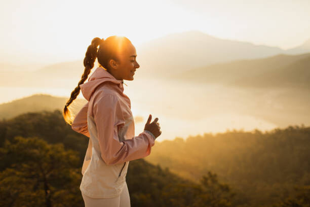 Poster Happy young woman running outdoors with