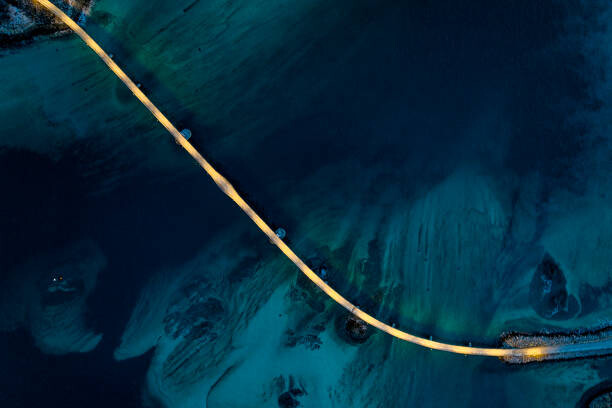 Poster Illuminated bridge in the cold arctic sea at dusk