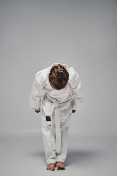 Poster Karate girl bowing and saluting