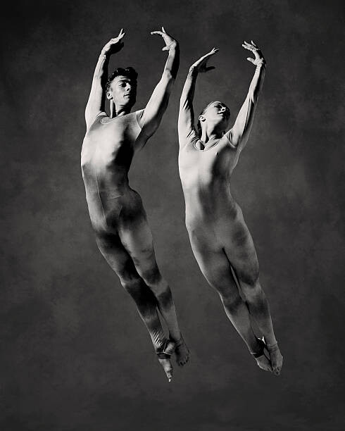 Плакат Male and female dancers in mid-air leap (B&W)