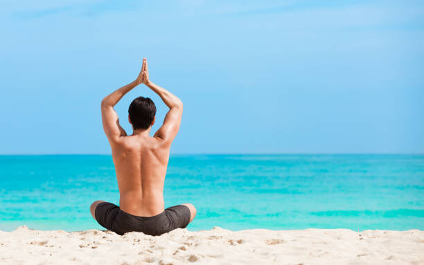 Плакат Man meditating on the beach