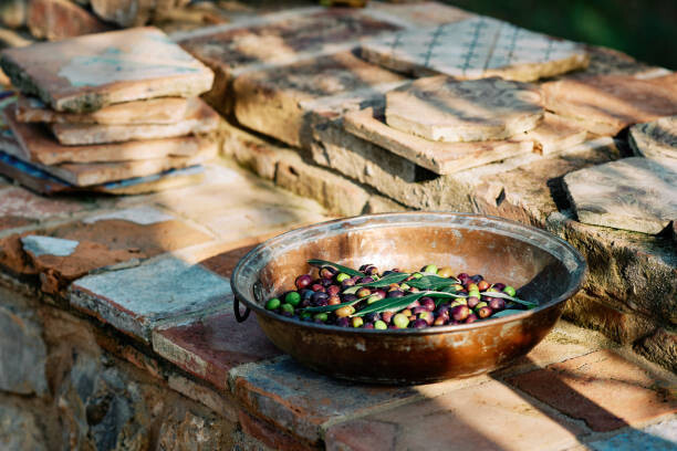 Poster Olive fruits in container kept on paving stones