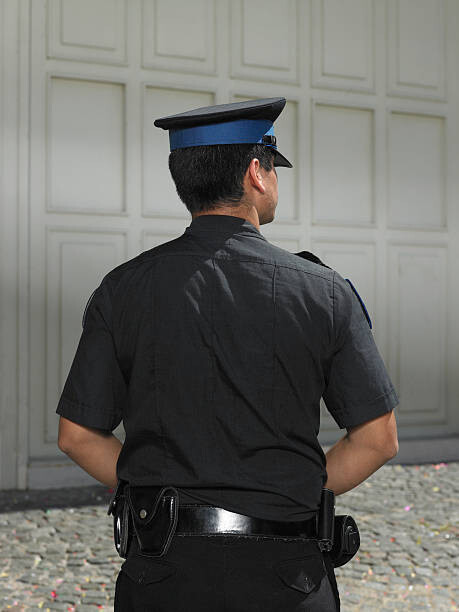 Poster Policeman standing in street, rear view