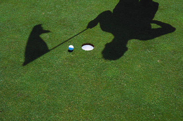 Poster SHADOW OF GOLFER & FLAG AT HOLE WITH BALL