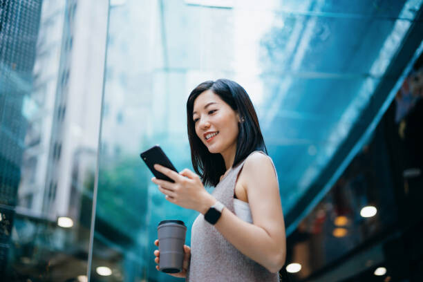 Poster Successful young Asian businesswoman holding a