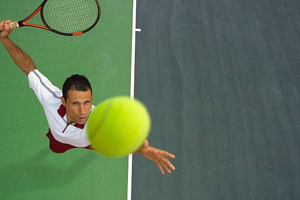 Poster Top View of Male Tennis Player Mid-Serve