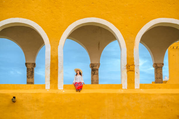 Poster Woman sitting outside the Izamal Monastery,