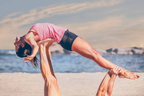 Плакат Young sporty woman practicing acroyoga exercises