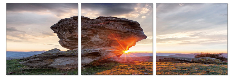 Quadro Sun setting behind a rock