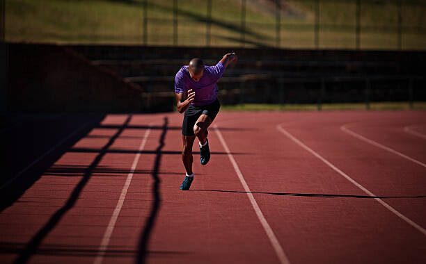 Quadro em tela Male runner sprinting at stadium