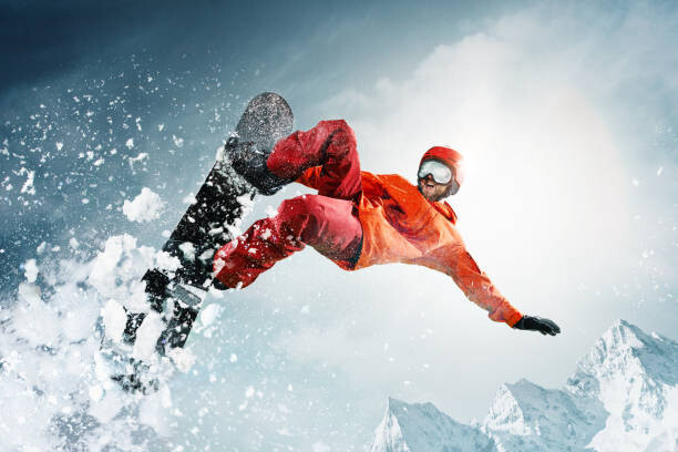 Quadro em tela Snowboarder jumping through air with deep