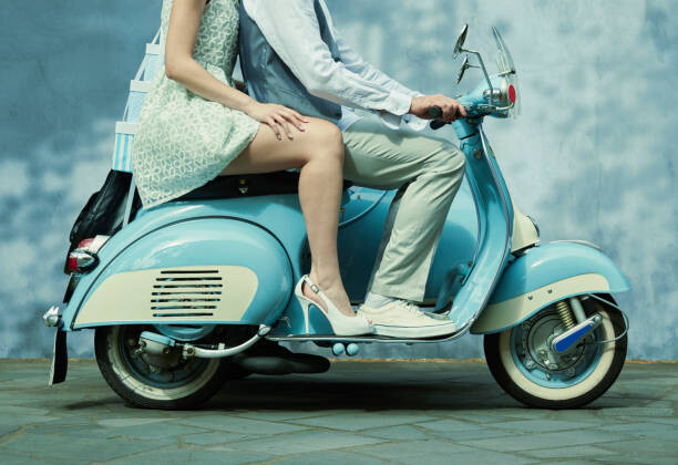 Wall Mural Couple riding vintage scooter
