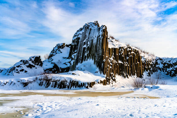 Wall Mural Rock organ pipes in winter time
