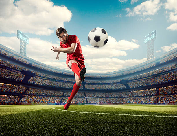 Wall Mural Soccer player kicking ball in stadium