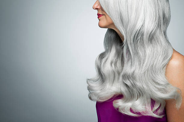 Картината върху платно Cropped profile of a woman with long, gray hair.